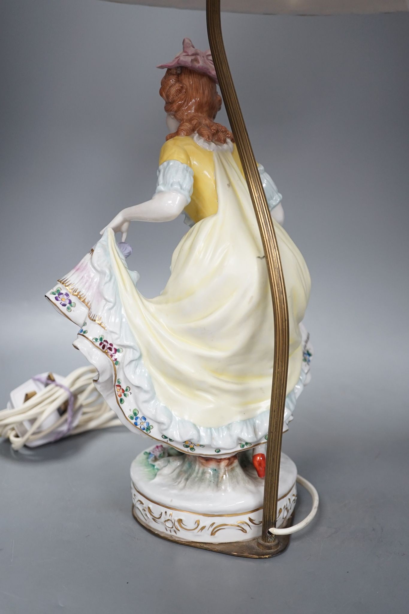 A German porcelain ‘dancing lady’ lamp, figure 29 cms high.
